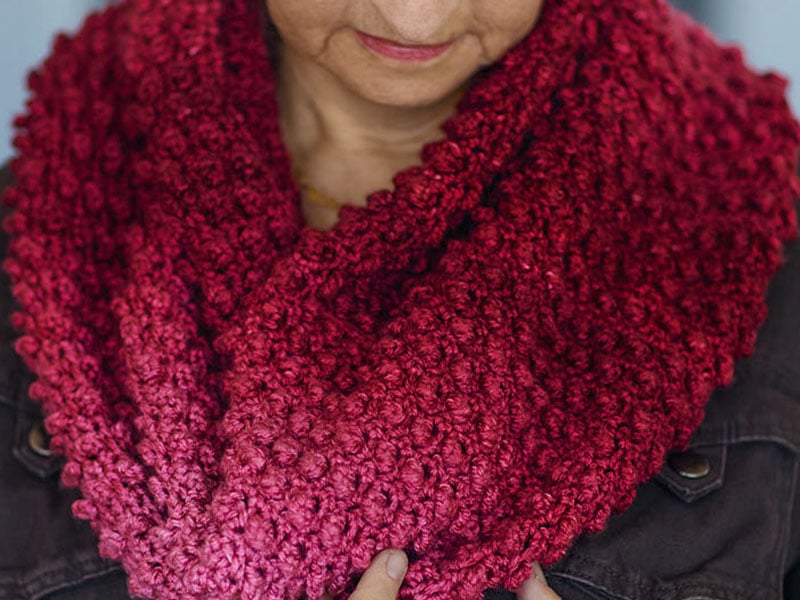 Cranberry crochet cowl with a deeply raised texture, worked in Mary Maxim Bag-O-Day Tonal Hues gradient yarn