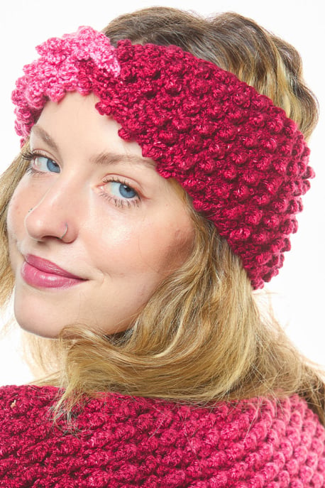 Cranberry crochet headband with a twisted front, worn with the matching cowl