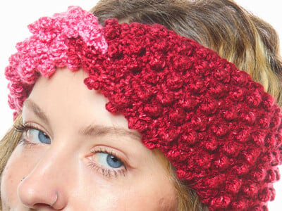 Cranberry crochet headband with a twisted finish and a deeply raised texture