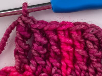 A finished double treble crochet stitch, the tall stitch used in the Cranberry Harvest patterns.