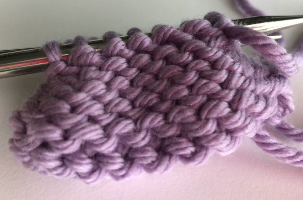 Sock turned inside out with the purl side facing, live toe stitches on two needles, ready for the Finchley Graft