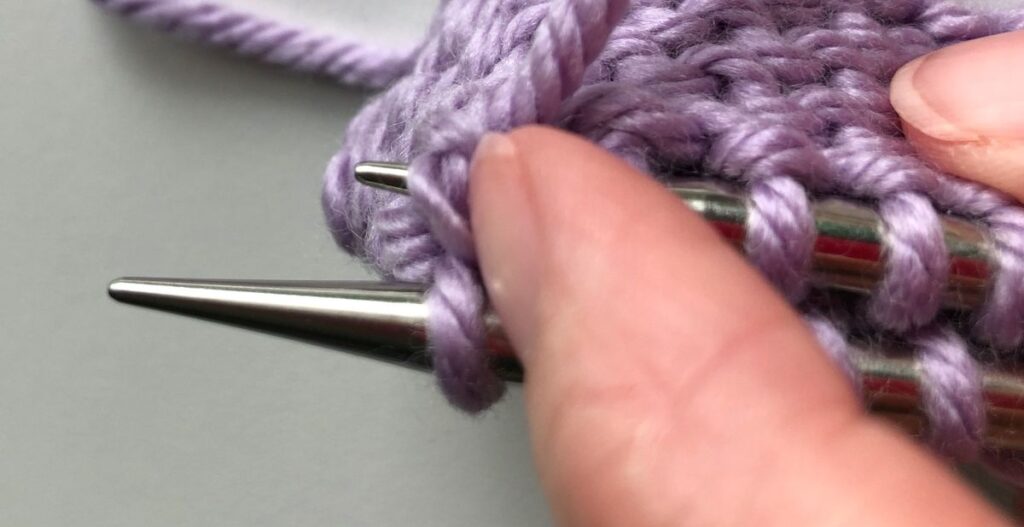 Pushing the first stitch off the front needle in step 2 of the Finchley Graft